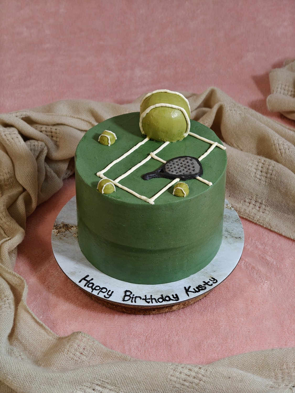 Sage-green padel court birthday cake with 3D fondant racquet